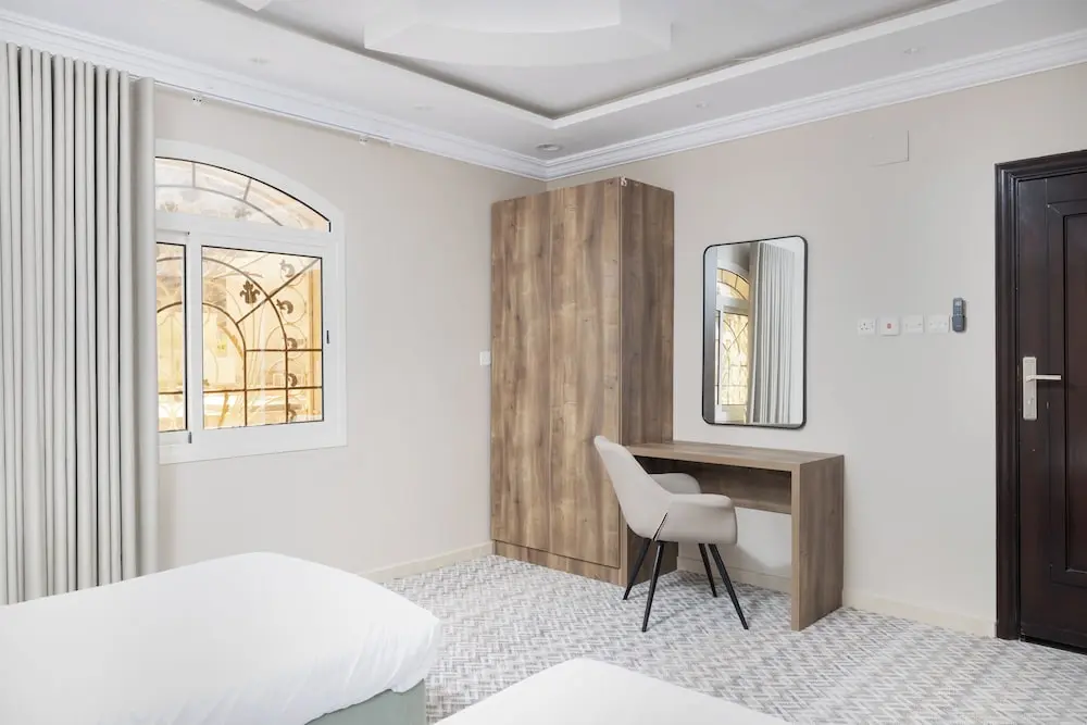 Nozol Noor managed guest room with desk and wardrobe